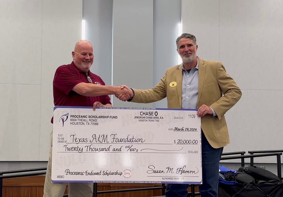 Mark Waller (left) presenting a check for scholarships to Jason Tieman (right)