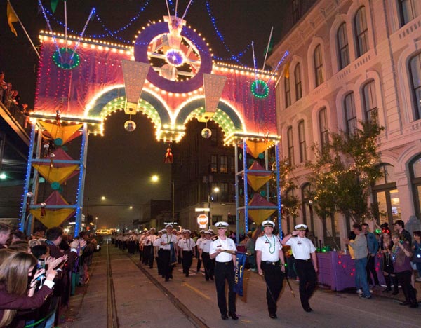 Texas A&M Maritime Academy cadets are cheered on by onlookers and supporters as they march in last year's The Knights of Momus Grand Night Parade. 