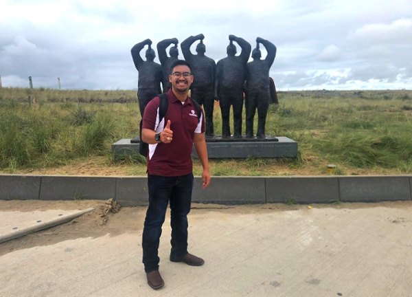 Marine resources management student Gregory Grimm ’19 poses in front of a statue near one of the natural coastal barriers in the Netherlands.