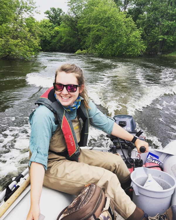 Former Student Zoe Cross ’18 navigates a raft through a river in Minnesota as part of the National Rivers and Streams Assessment (NRSA) project. 