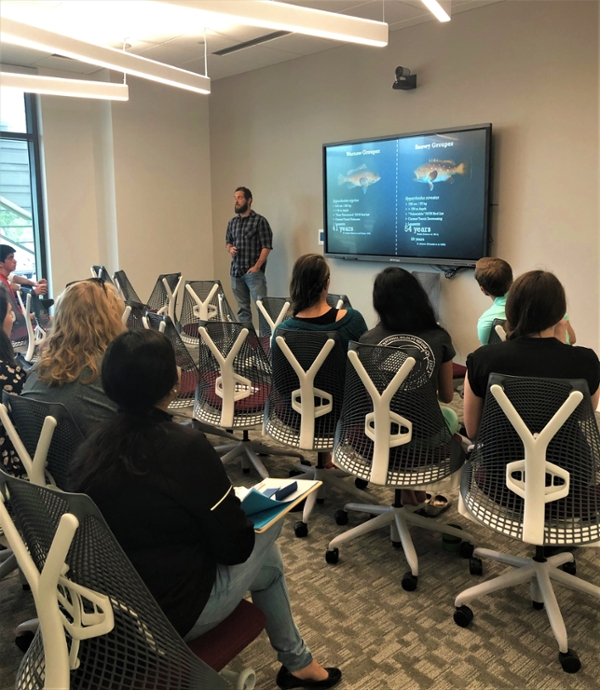 Phil Sanchez, a Ph.D. student in the Department of Marine Biology, gives a presentation about the possibility of 100-year-old fish in the Gulf of Mexico to a group of grad students and faculty at the Research Symposium Lightning Talks in 2019.