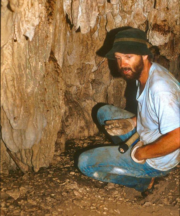 Dr. Tom Iliffe collects snail specimens from inside a cave during a trip to the South Pacific in 1987. 