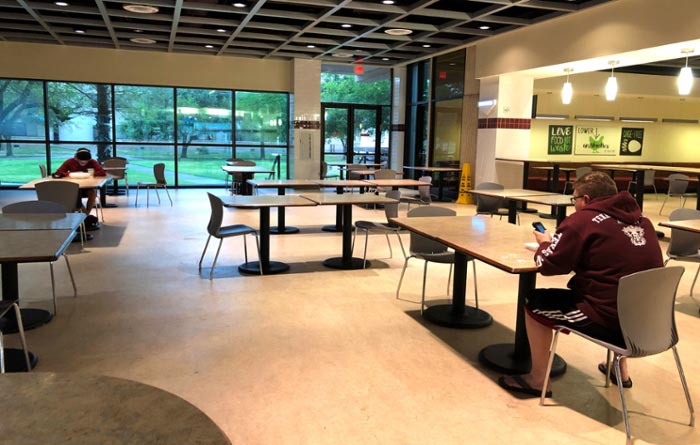 Students in the Captain's Landing practice social distancing. Tables have been removed to facilitate and encourage only small groups and manipulated so that diners are seated six feet apart to accommodate CDC guidelines. 
