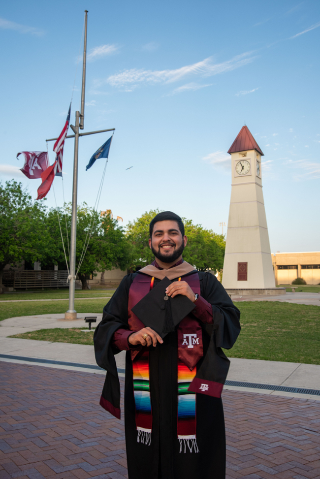 Castro proudly wears his Hispanic heritage stole while posing for graduation photos on the Galveston Campus. 
