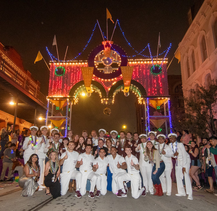 Students and guests of the annual Mardi Gras party under the historic Powell Arch.