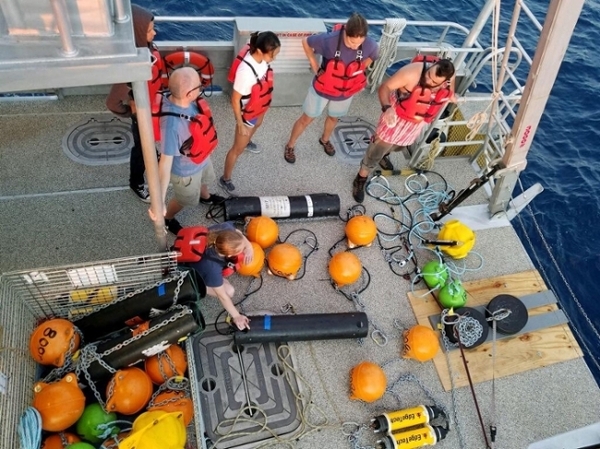 Sirovic and a team prepare to deploy bioacoustic equipment aboard the RV Trident